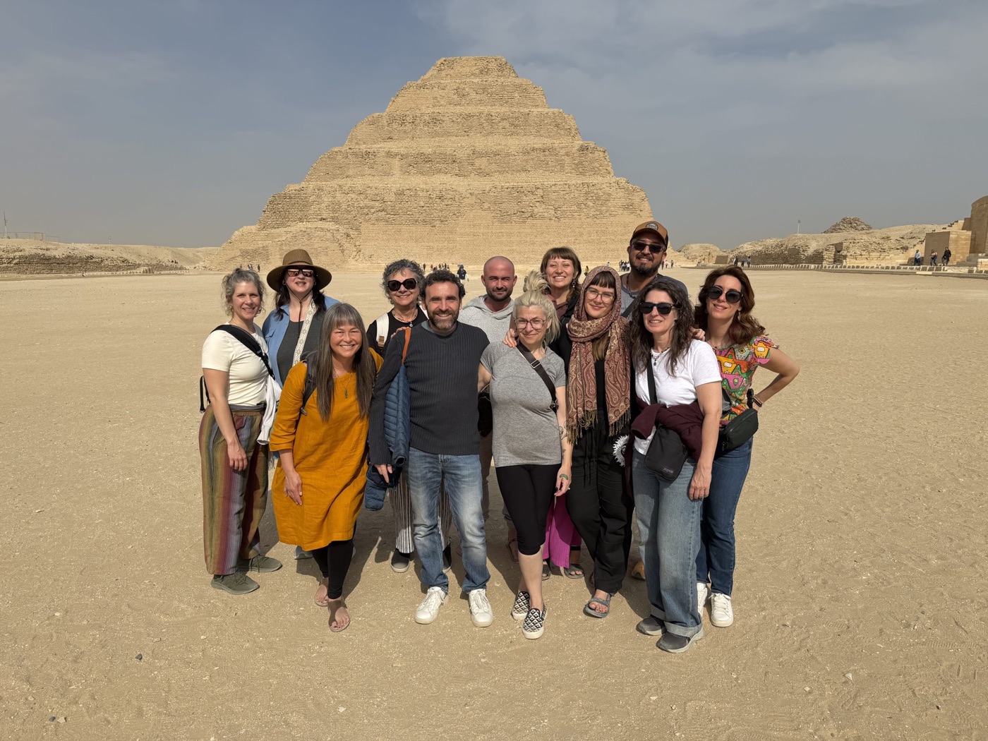A retreat group gathered in front of an ancient stepped structure in Egypt
